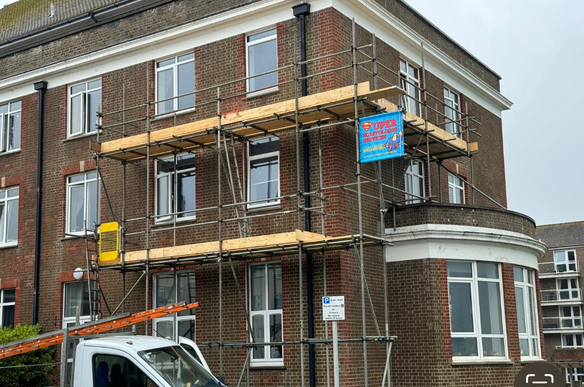 Scaffold on the upper floors of a red-brick block of flats